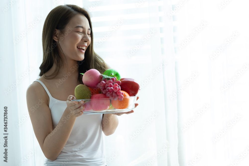 Asian woman holding fresh healthy fruits and happiness,Health care Concept Asian woman holding fresh healthy fruits and happiness,Health care Concept