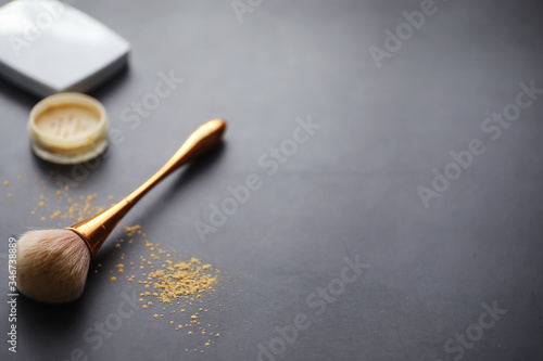 Powder and makeup brush. Brown powder on the background. Makeup products. Style concept.