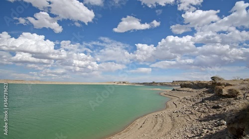 Time lapse over Millsite Reservoir in Utah as clouds move over the colorful lake water. photo