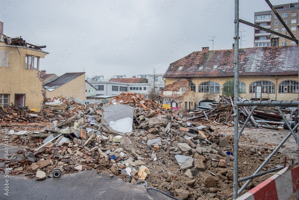 Fototapeta premium Demolition of old houses in an urban aerea. Destruction or demolishing old house to make way for a new house in a city neighbourhood on a cold day.