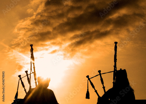 Wallpaper Mural Scottish Skye Serenade: Bagpipers in Sunset Silhouette