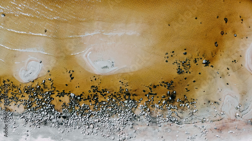 Ocean shore view from quadcopter, sand and rocks on the sea coast. Ocean day card. Ocean shore top view