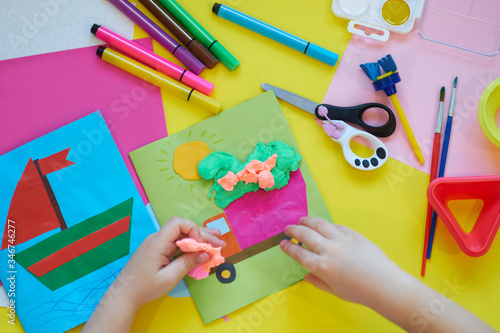 School supplies  stationery on yellow background - space for caption. Child ready to draw with pencils and make application of colored paper. Top view.