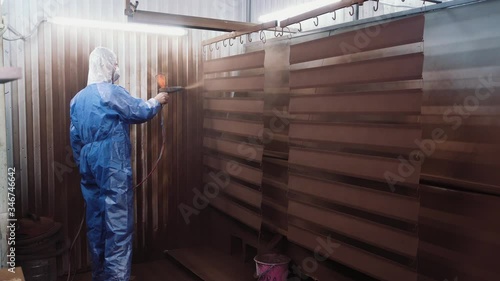 Applying a second coat of paint to the painted parts using a professional gun