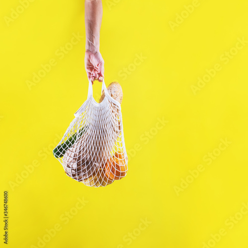 Fototapeta Naklejka Na Ścianę i Meble -  Woman hand holding string shopping reusable bag