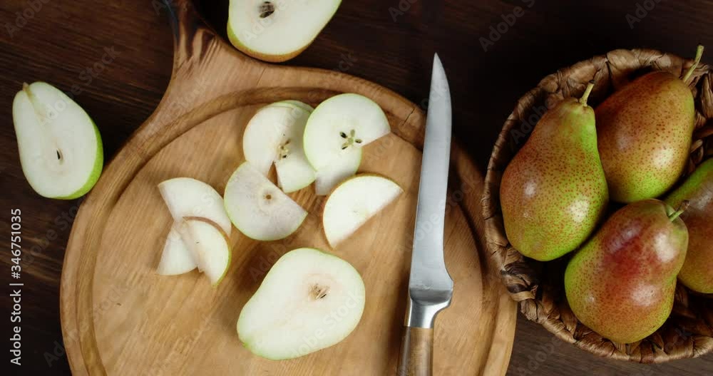 Slices of pear on cutting Board with knife slowly rotate. Slices of pear on cutting Board with knife slowly rotate.