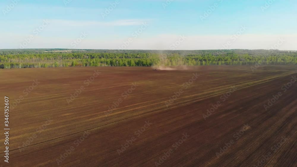 Aerial drone view of agriculture machinery on spring field Aerial drone view of agriculture machinery on spring field