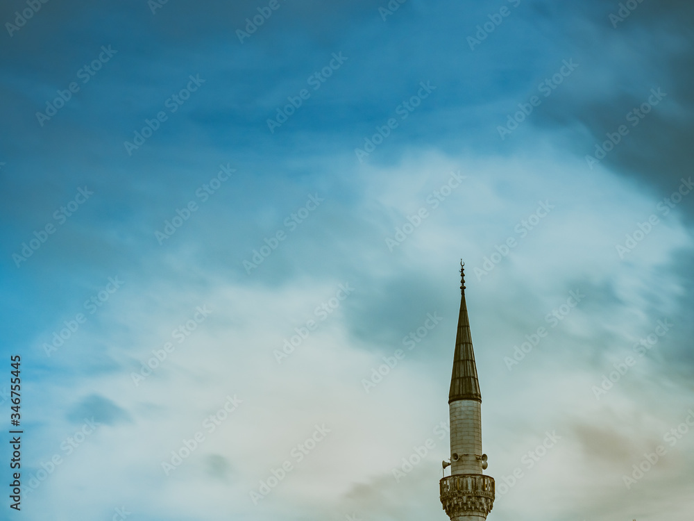 Minaret of a Muslim mosque on the background of the cloudy sky. Minaret of a Muslim mosque on the background of the cloudy sky.