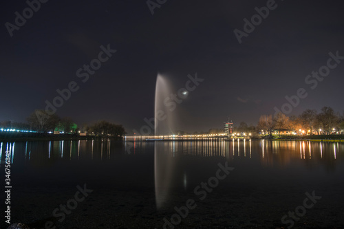 Big fountain in the middle of lake at summer night, Belgrade's famous landmark, Ada Ciganlija