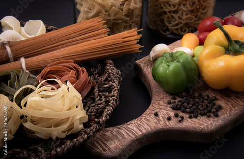 Some raw pasta and fresh vegetables. photo