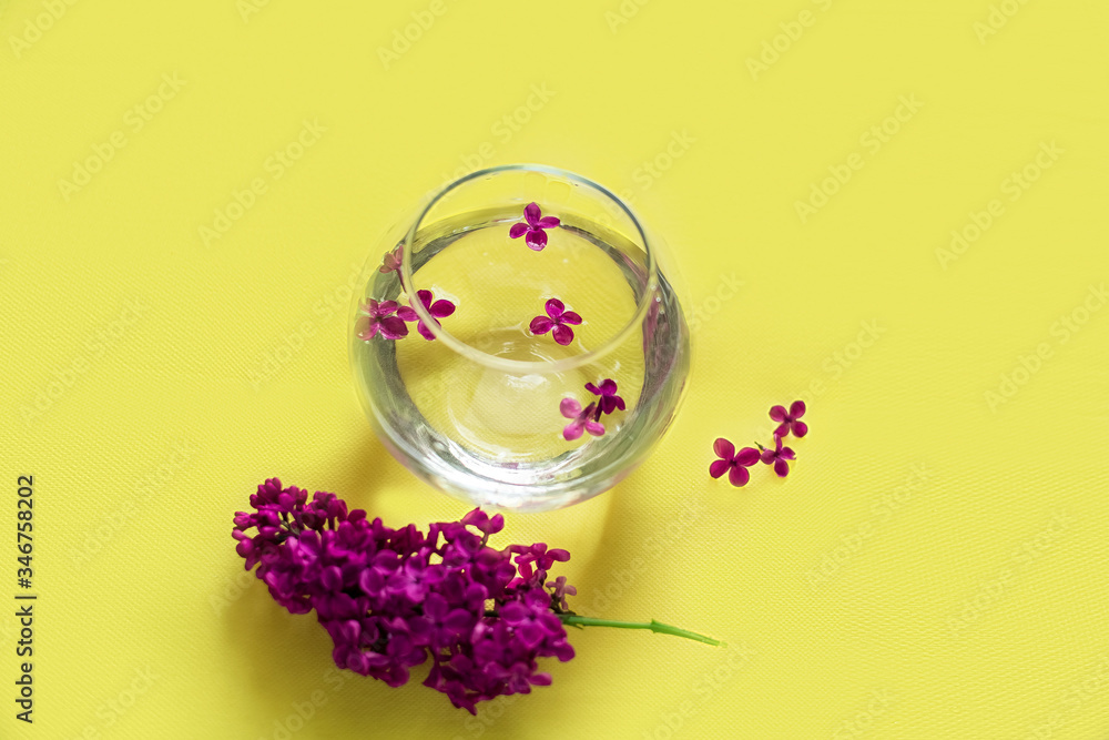 purple lilac in a round vase, round vase with water, glass round vase, purple lilac on a yellow background, purple lilac, branch of lilac purple lilac in a round vase, round vase with water, glass round vase, purple lilac on a yellow background, purple lilac, branch of lilac