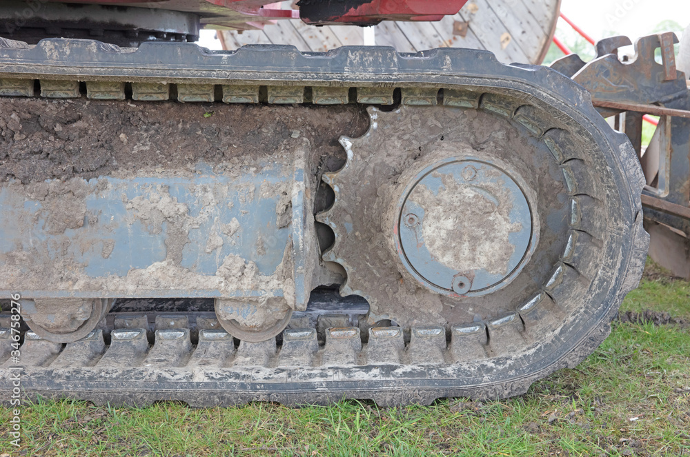 Rubber caterpillar bulldozer close-up, used and dirty Rubber caterpillar bulldozer close-up, used and dirty