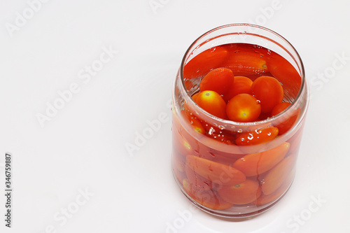 Cherry tomatoes in glass jar , A group of tomatoes in water