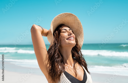 Stylish casual woman enjoying sun at tropical beach photo