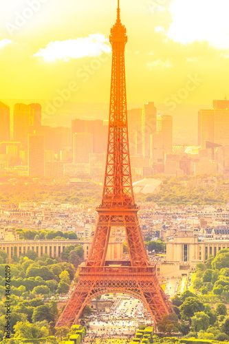 sunset on cityscape skyline of Paris with Eiffel Tower on background. Seasonal picturesque background in summer. Scenic wallpaper with Eiffel Tower. Vertical shot.