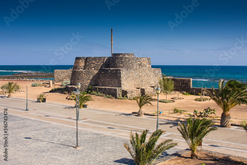 Historic fortress complex on the beach promenade of Caleta de Fuste, Fuerteventura, Canary Islands, Spain, Europe photo