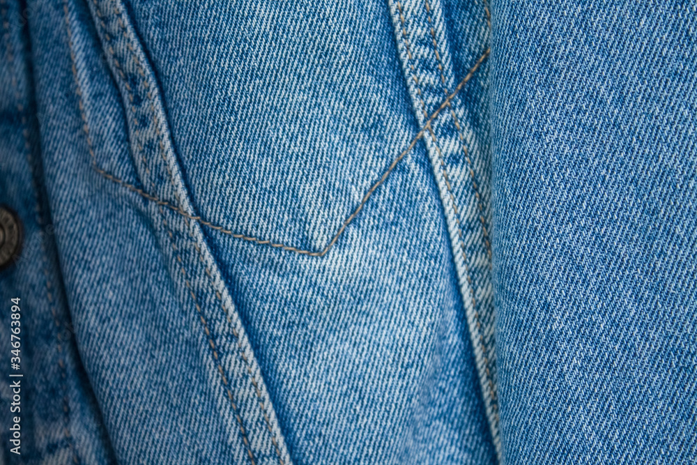 Jeans and denim jacket close-up in blue with straight seams. Wardrobe Update. Top view. Flat lay composition Jeans and denim jacket close-up in blue with straight seams. Wardrobe Update. Top view. Flat lay composition
