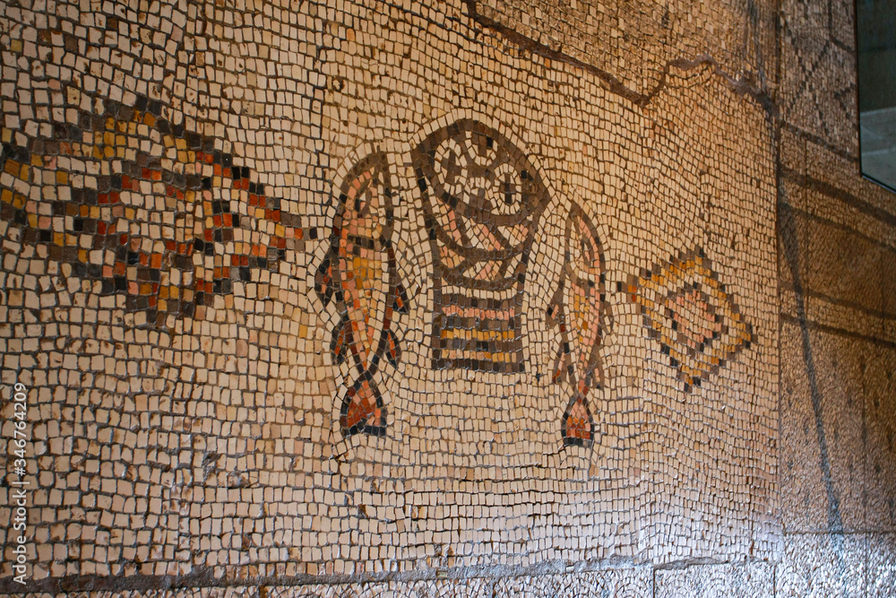 Tabha, Israel, Ancient mosaic, image of two fish and five loaves. Church of the Multiplication of Bread and Fish (Tabha) The concept is the history of Christianity.