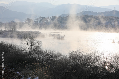 Winter morning landscape of water misty river. Soyang River, Chuncheon City, Korea © YOUSUK