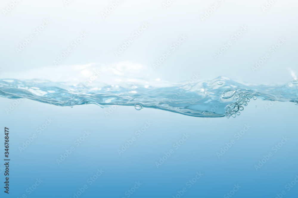 Water splash on blue background. Aqua flowing in waves and creating bubbles. Drops on the water surface feel fresh and clean. Water splash on blue background. Aqua flowing in waves and creating bubbles. Drops on the water surface feel fresh and clean.