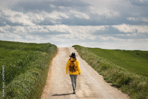 Never knows what is behind the horizon. Woman hiking on road. Getting out of your comfort zone concept photo