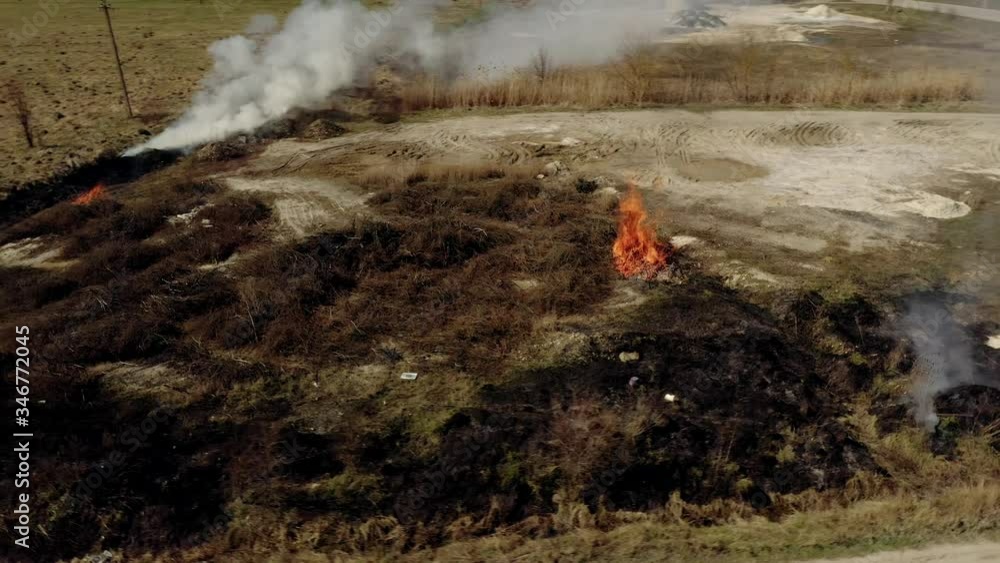 Air pollution caused by wildfires, clouds of smoke above the burning field, aerial footage. Epic natural disaster, forest fire in summer Air pollution caused by wildfires, clouds of smoke above the burning field, aerial footage. Epic natural disaster, forest fire in summer