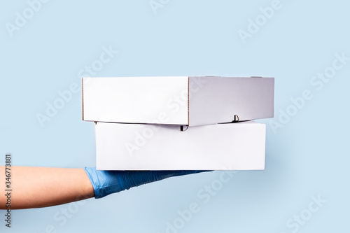 Safe delivery with care for yourself and others. Front view to delivery box and female hand.