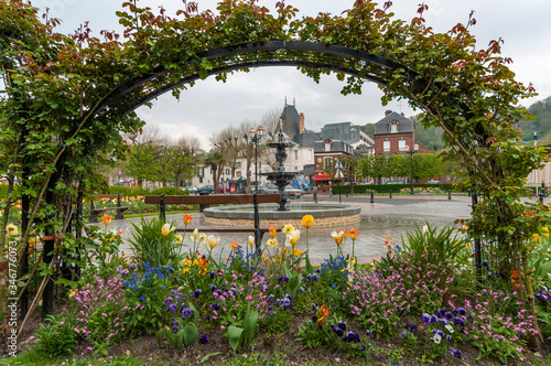 Fountain and blooming flowers at Place Albert Sorel in Honfleur, France photo