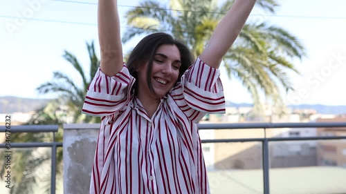Beautiful, happy and expressive girl in a striped shirt