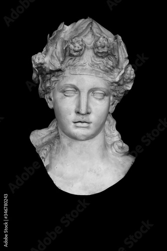 Close up ancient stone statue of god of wine Dionysus (Bacchus). Isolated on black background.