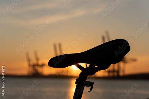 Profile of a bicycle seat at sunset.