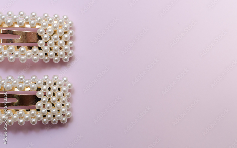 hair pins with pearls on a pink background hair pins with pearls on a pink background