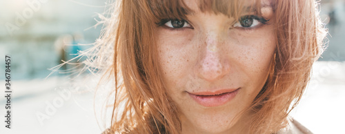 Portrait close up of a beautiful caucasian woman outdoor	
 photo