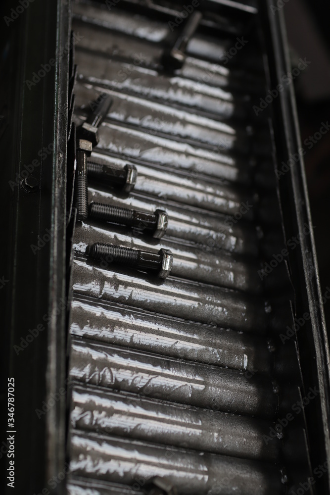 the raw material of the screw and machine producing bolts at the factory the raw material of the screw and machine producing bolts at the factory