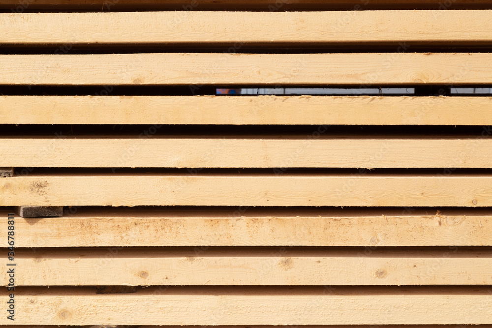 Obraz premium Edged boards in stock, ready for sale. Warehouse of construction materials.