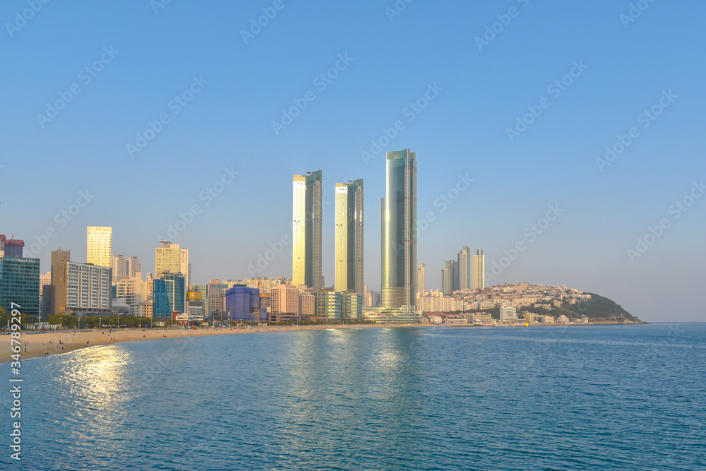 Busan city, South Korea - NOV 02, 2019: People relaxing and having fun on Haeundae Beach.One of the famous beautiful attractions in Busan. Busan city, South Korea - NOV 02, 2019: People relaxing and having fun on Haeundae Beach.One of the famous beautiful attractions in Busan.