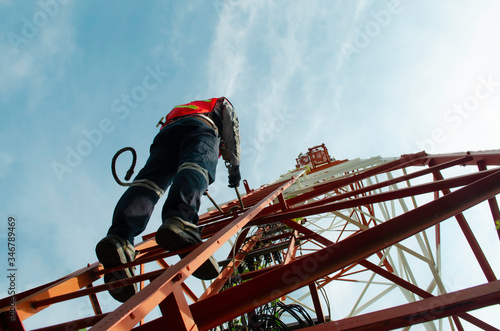 engineer climb high tower to maintenance working,safety work with PPE,telecom tower for 5G network