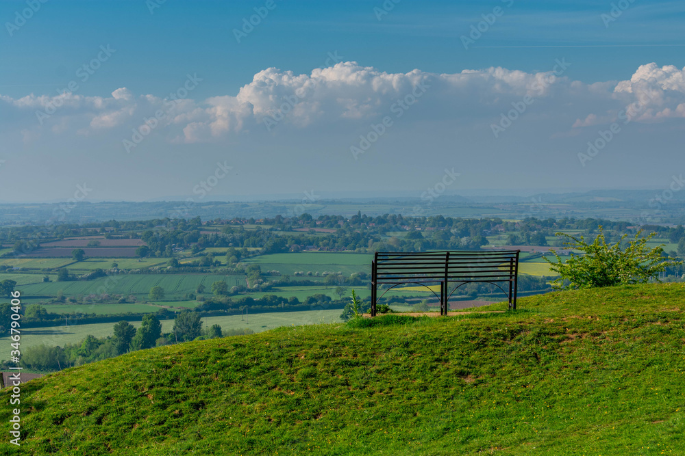 A single bench facing the somerset countryside and valleys. The peaceful scenic viewing point is on top of Ham hill in Somerset. A single bench facing the somerset countryside and valleys. The peaceful scenic viewing point is on top of Ham hill in Somerset.