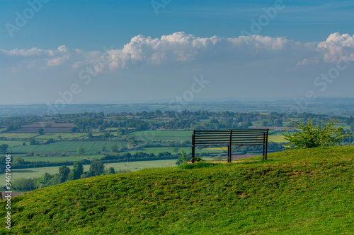 A single bench facing the somerset countryside and valleys. The peaceful scenic viewing point is on top of Ham hill in Somerset.