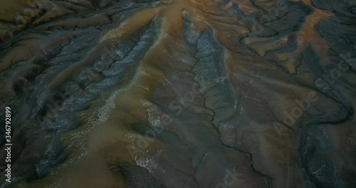 Aerial view moving away shot, Scenic view of the Utah Badlands Desert landscape, revealing the Factory Butte in the background. photo