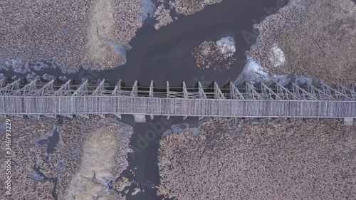 Down vertical aerial: Decommissioned rickety wooden railway trestle