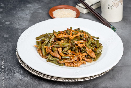 Roasted fern salad with meat in a white plate photo