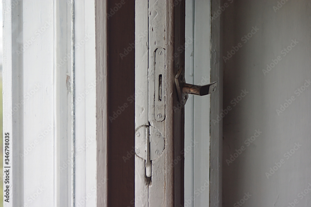 half-open sashes of an old wooden window half-open sashes of an old wooden window