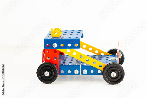 Machine made of metal constructor on a white background. Children's creativity, teaching children to design © Elena