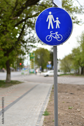 pPedestrian and bicycle sign on the sidewalk with blurred background