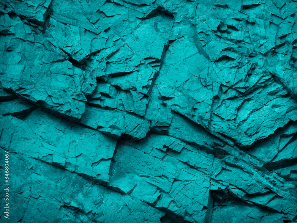 Blue green abstract background. Rock texture. Toned stone background. Close-up. A combination of dark turquoise color and beautiful mountain texture.