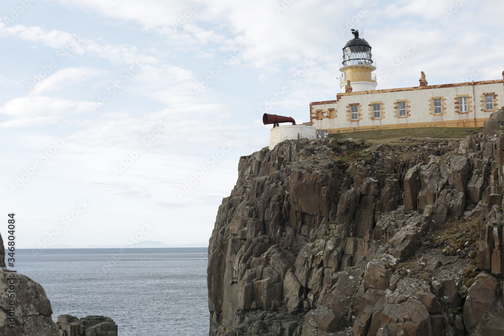A traditional lighthouse on a cliff. 