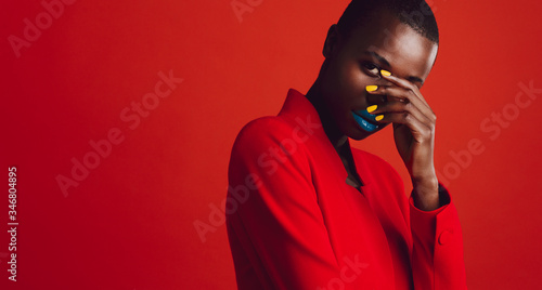 Glamorous female model on red background photo