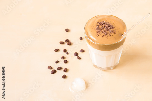 Dalgon coffee in a transparent glass on a wooden background
