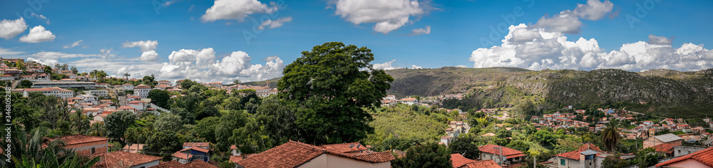 Panoramic view to historic town and mountains with blue sky, white clouds, trees, Diamantina, Minas Gerais, Brazil